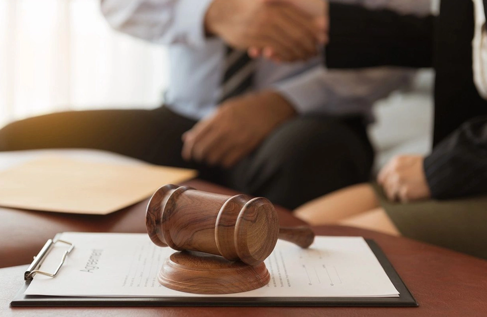 A judge 's gavel sitting on top of a table.